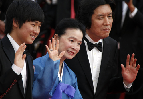 Cast members pose on red carpet for screening of film Poetry