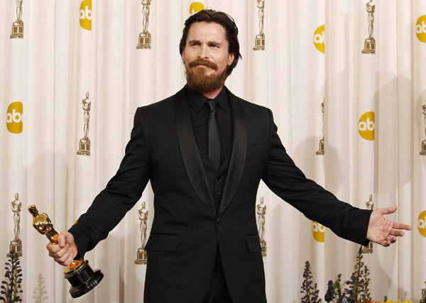 Actor Christian Bale reacts after winning the Oscar for Performance by an Actor