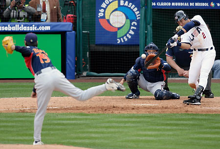 U.S. shortstop Derek Jeter (R) hits a 5th inning single against Japanese pitcher Koji Uehara (L) during the World Baseball Classic in Anaheim, California March 12, 2006. [Reuters]