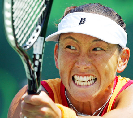 Ai Sugiyama of Japan grimaces as she returns a shot during her match against Svetlana Kuznetsova of Russia at the Nasdaq-100 Open tennis tournament in Key Biscayne, Florida March 28, 2006. 