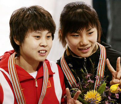 China's Meng Wang (L) and Sun-Yu Jin of South Korea smile after the awards ceremony for the women's 1500 meter final of the World Short Track Championships at Mariucci Arena in Minneapolis March 31, 2006. Jin won the event and Wang placed second.