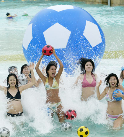 South Korean models pose with soccer balls during a promotional drive wishing South Korean soccer team's success in the 2006 Germany World Cup at Caribbean Bay swimming pool in South Korea's largest amusement park Everland in Yongin, about 50 km (31 miles) south of Seoul, May 11, 2006. 