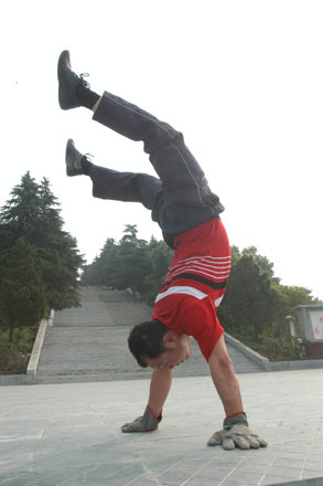 A Chinese man named Xing Hui climbs down the steps at a park in Xiangfan, central China's Hubei Province, June 20, 2006. Xing Hui, 41-year-old, likes boxing, swimming, and wrestling, but these exercises do little help to his neck suffering from pain for a long time. Half a year ago, Xing Hui began to practice climbing down the steps, and now his neck is fine, sources said. [newsphoto]