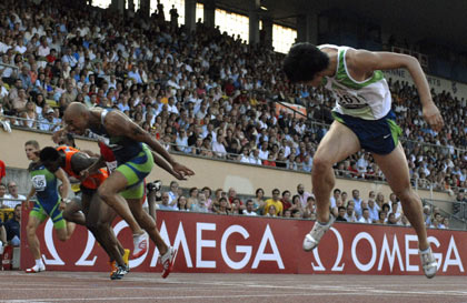 Liu Xiang of China (R) crosses the finish line past Dominique Arnold (L) of the U.S. to set a new world record during the men's 110-metre hurdles race at the IAAF Super Grand Prix athletics meeting in Lausanne July 11, 2006. Liu won the race in a world record time of 12.88 seconds. 