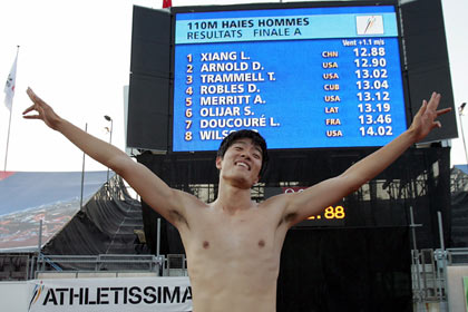 Liu Xiang of China celebrates setting a new world record in the men's 110-metre race at the IAAF Super Grand Prix athletics meeting in Lausanne July 11, 2006. Liu won the race in a world record time of 12.88 seconds. [Reuters]