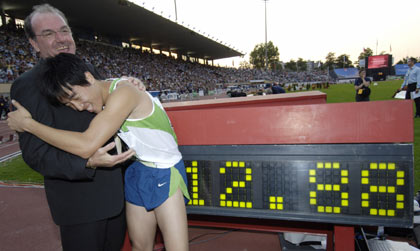 Liu Xiang of China celebrates setting a new world record in the men's 110-metre race at the IAAF Super Grand Prix athletics meeting in Lausanne July 11, 2006. Liu won the race in a world record time of 12.88 seconds. [Reuters]