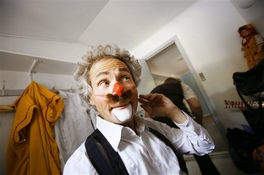 Danish clown Benny Schumann, 61, applies makeup while preparing for a show in Copenhagen, Denmark Wednesday Aug. 9, 2006. Clowns from Italy, Belgium, Denmark, Spain and Russia among other places are gathering for the 11th International Clown Festival in Denmark held Aug. 10-20 at the Bakken amusement park 20 kilometers (13 miles) north of Copenhagen. 