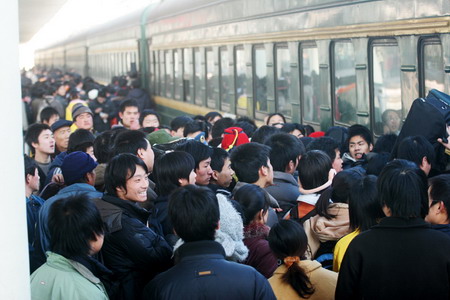 Passengers board a train at a railway station in Shijiangzhuang, North China's Hebei 