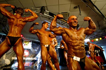 Competitors pose during a body building competition in Budapest May 14, 2007. 