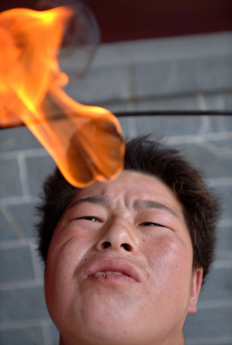 Fire-swallowing man