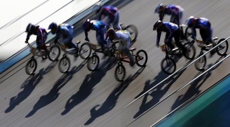 Competitors ride over the course during the UCI BMX Supercross World Cup at Laoshan Bicycle Moto Cross (BMX) venue in Beijing August 21, 2007.[Xinhua]