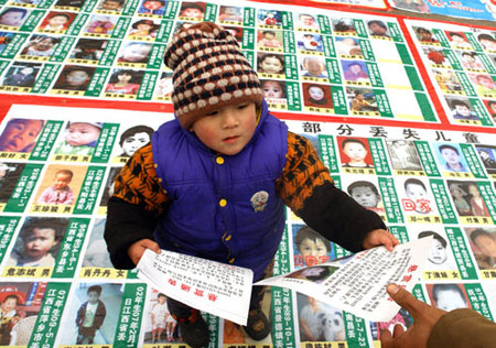 Poster with photos of 2,700 missing children