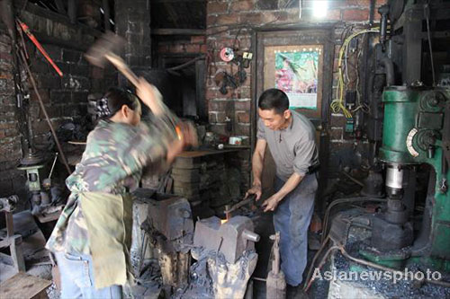 Husband-wife team work together as blacksmiths