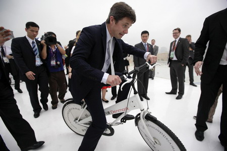 Denish crown prince rides a bike on Expo