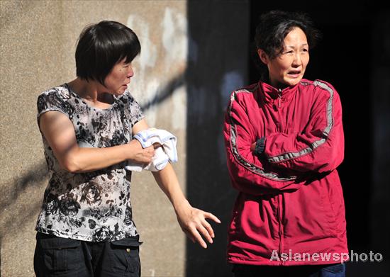 Woman trembles with cold under scorching sun