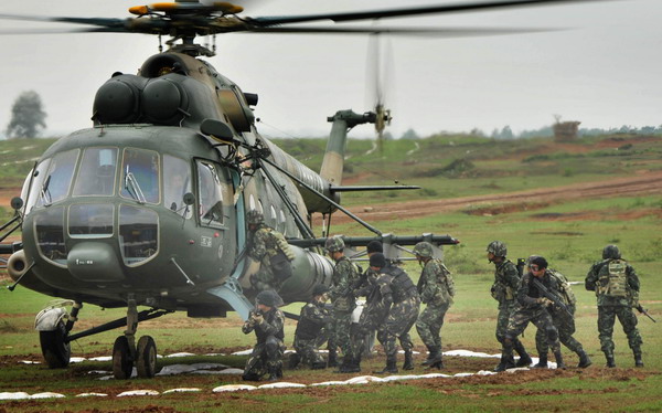 Soldiers rope down from helicoper in joint drill