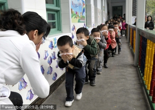 Preschool children practice fire drill