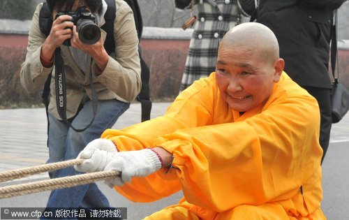 Buddhist nun shows off her strength pulling cars