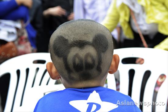 Boy wears Mickey Mouse on his head