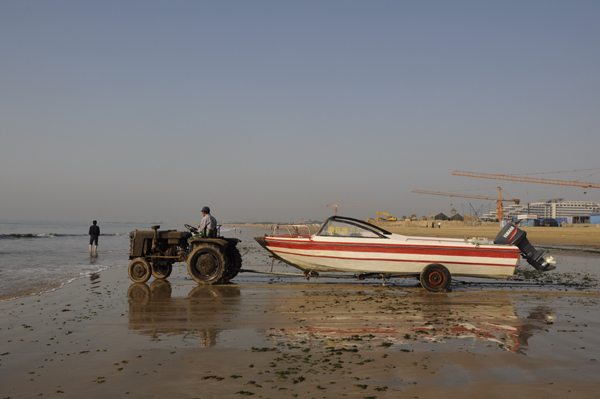 Tractor gives a speed boat a jump start