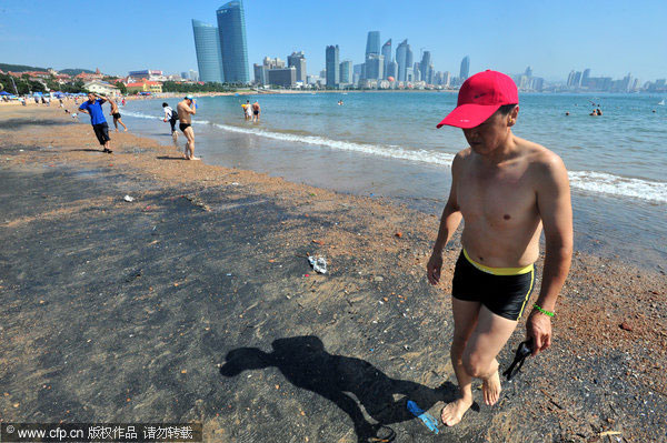 E China beach covered by unknown black substance