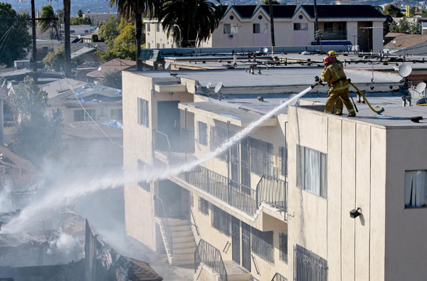 Los Angeles firefighters battle a house fire