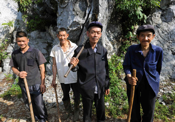 Four men move a mountain for their offspring