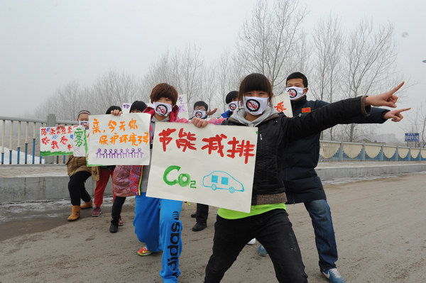 Masked students call for clean environment