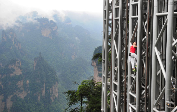 French 'spiderman' scales highest outdoor elevator