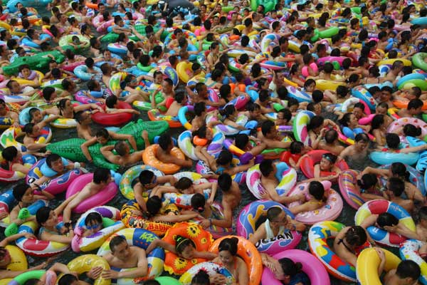 People cram in water pool to cool off