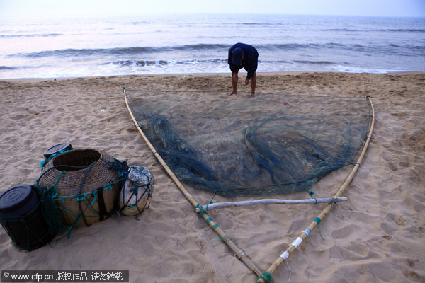 Fisherman stilted against power of the sea