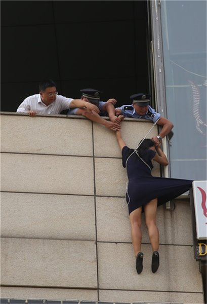 Woman pulled off the ledge in Beijing