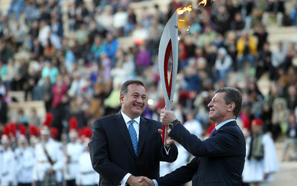 Olympic flame handed over to Russian hosts