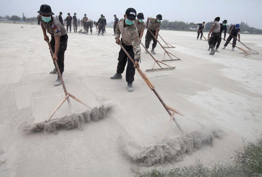 People clear volcanic ash in Indonesia