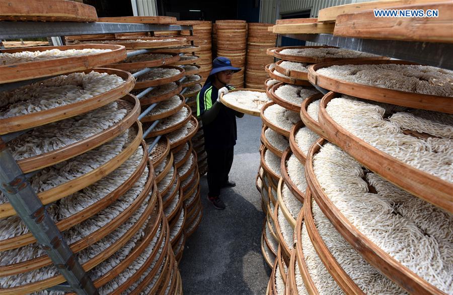 Workers make Kuanmiao noodles in SE China's Taiwan