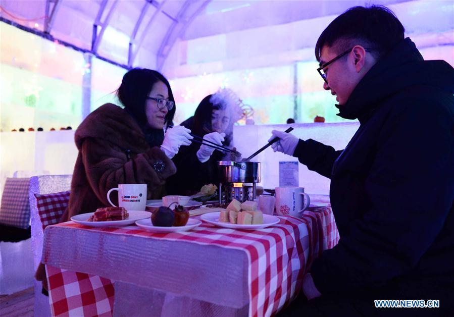 People enjoy meal in ice restaurant in NE China
