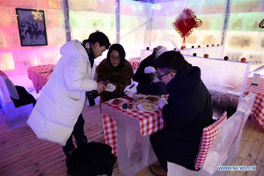People enjoy meal in ice restaurant in NE China
