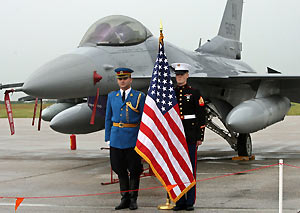 Serbian (L) and U.S. army soldiers stand in front of one of two U.S. F-16 military airplanes at the Batajnica military airport near Belgrade June 23, 2006. 