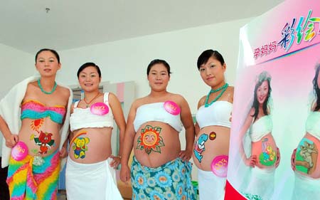 Paintings on pregnant woman's belly