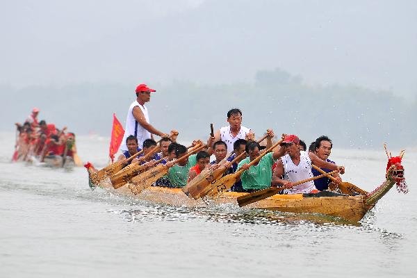 Participants compete in dragon boat races before Dragon Boat Festival