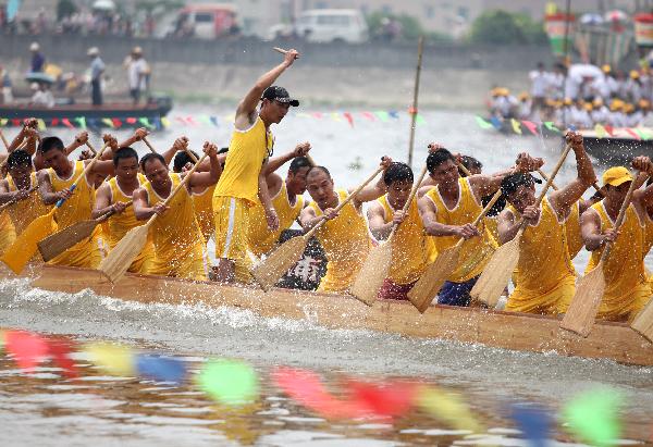 Participants compete in dragon boat races before Dragon Boat Festival
