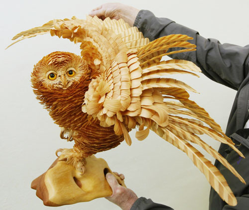 A life-sized owl sculpture made from cutting chips