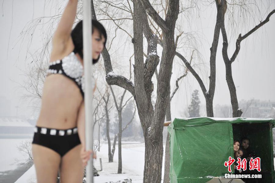 Pole dancers practice outside in cold winter