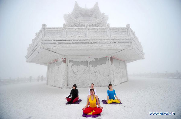 Women do yoga after snowfall