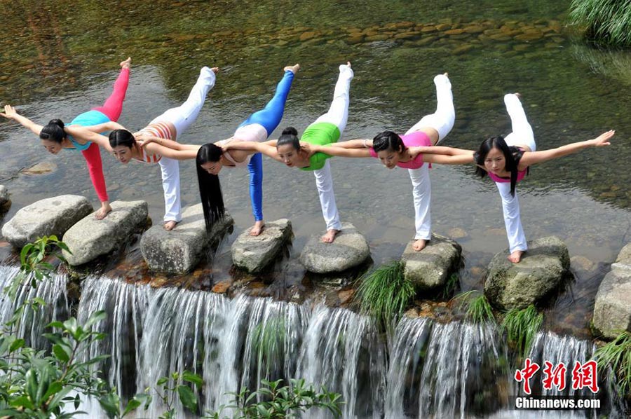 Yoga performed around waterfall in Jiangxi