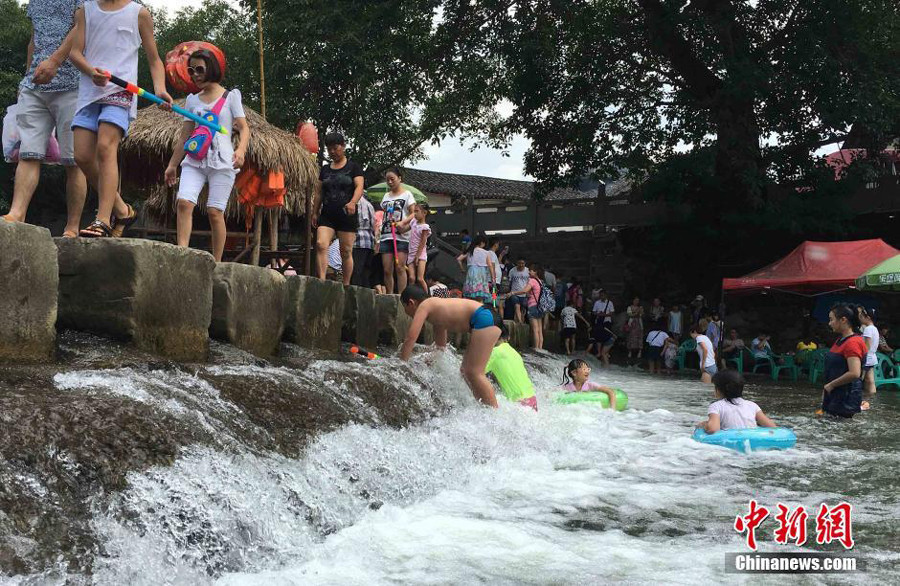 Playing Mahjong in the river: China's new way of tackling the summer heat