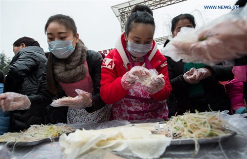 Chengdu people make spring rolls to welcome new year