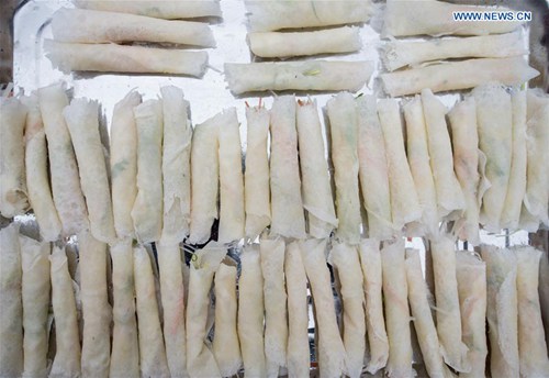 Chengdu people make spring rolls to welcome new year