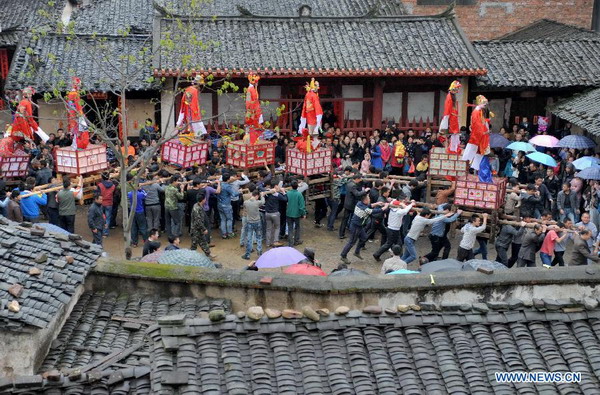 People attend Zougushi Parade in Liancheng