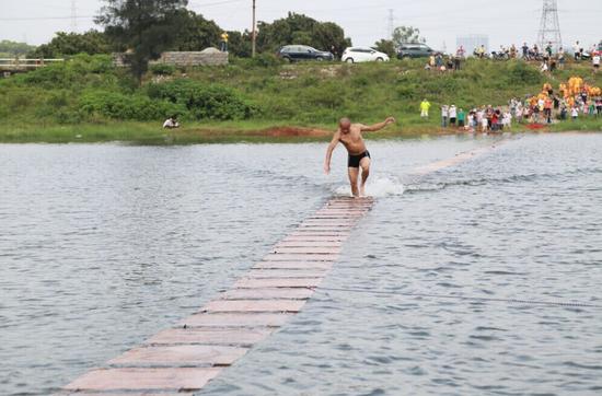 Monk walks on water for a cause